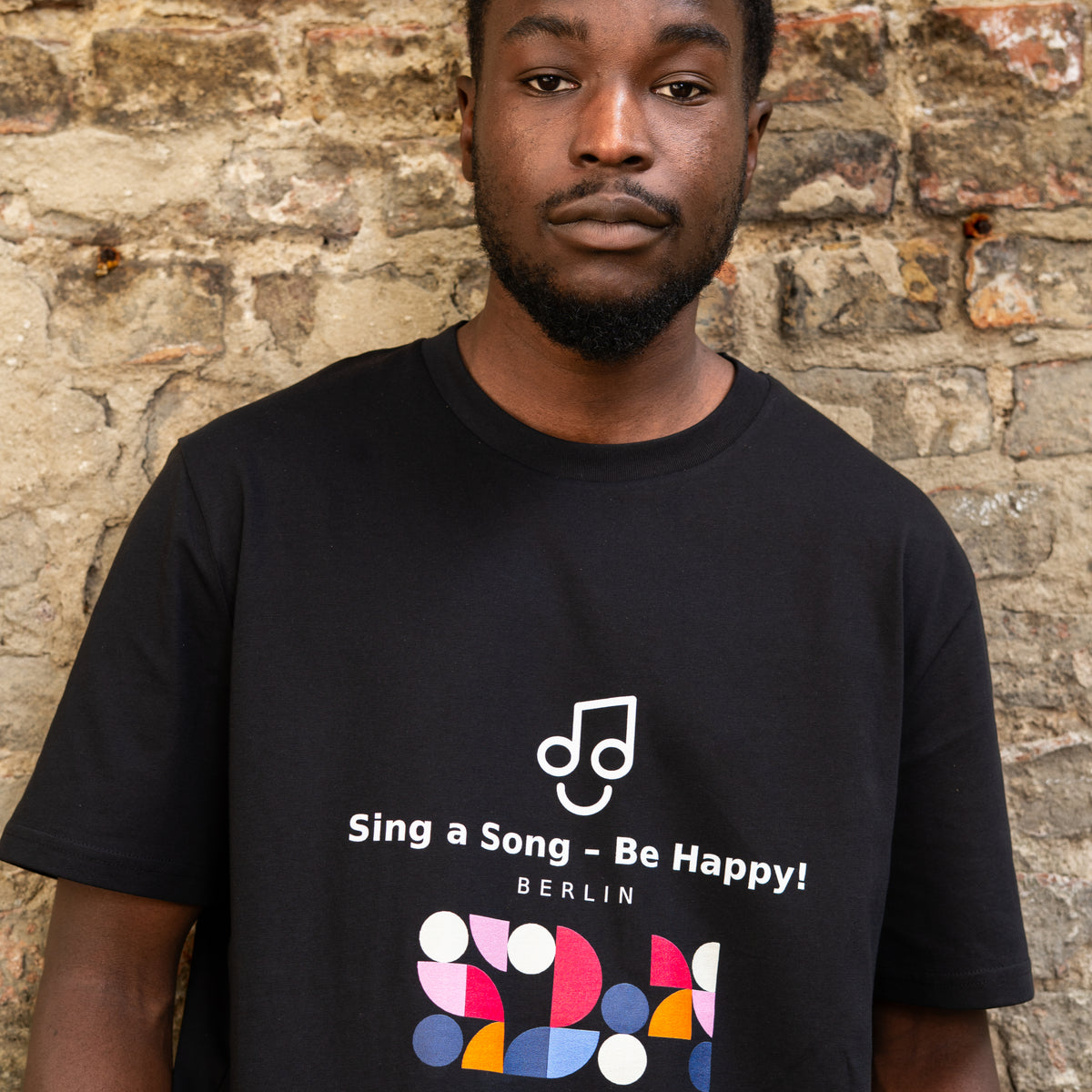 Sing a Song – Be Happy! T-Shirt Unisex Oversized Schwarz